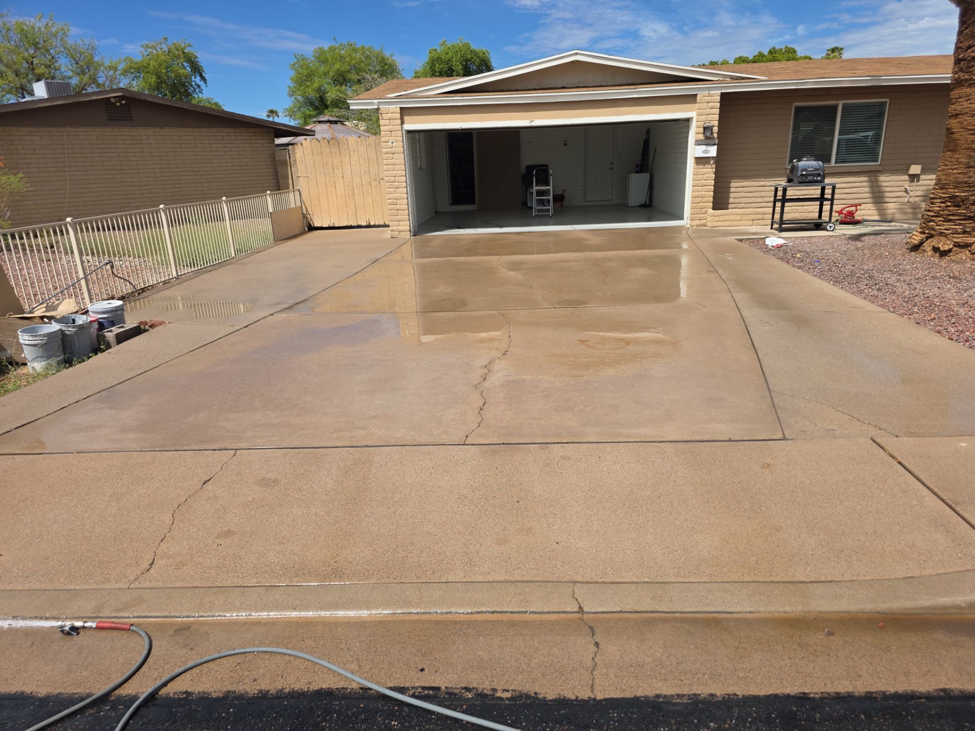 Arizona residential driveway during stain treatment and cleaning